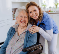 Lady and elderly woman smiling at the camera