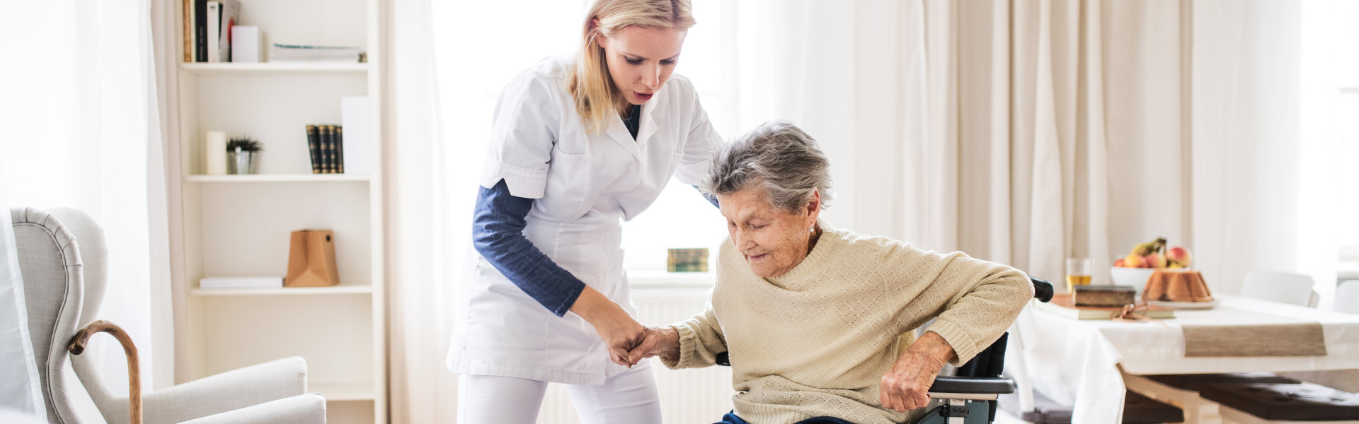 Lady helping elderly to stand up