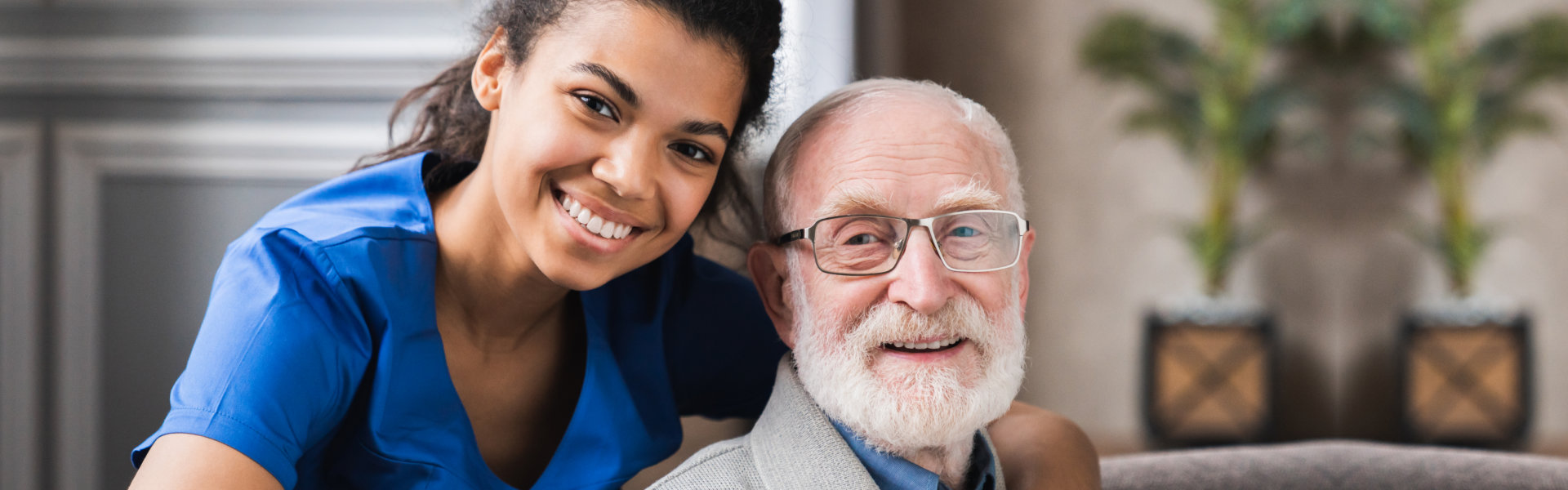 lady and elderly man looking at the camera and smiling