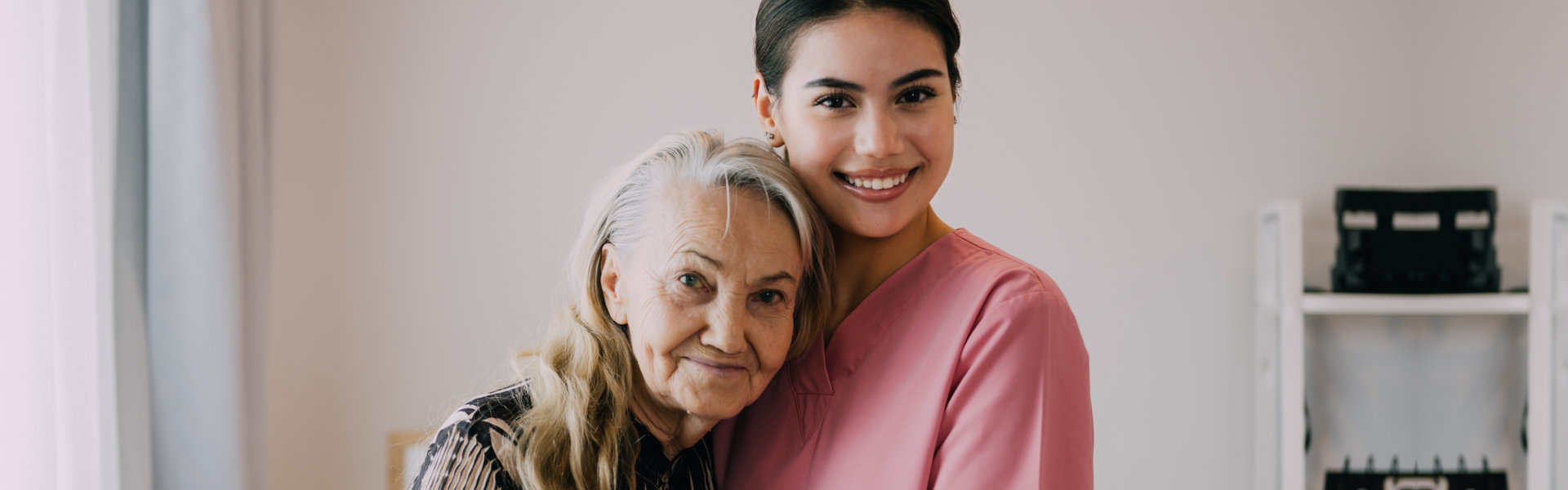 elderly hugging a lady